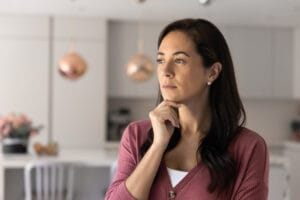 Woman reflecting quietly, illustrating self-criticism and inner critic therapy in New Jersey